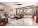 Open living area with tiled floors, white sofas, and natural light from sliding glass doors at 227 W Lantern Way, San Tan Valley, AZ 85143