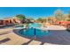 Community pool with sun loungers, umbrellas, hot tub, and desert landscaping at 227 W Lantern Way, San Tan Valley, AZ 85143