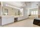 Bright bathroom featuring double sinks, vanity, and a soaking tub for a spa-like experience at 22742 N 90Th St, Scottsdale, AZ 85255