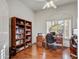 Office features wood floors, built-in shelves, desk, and a large window providing natural light at 22742 N 90Th St, Scottsdale, AZ 85255