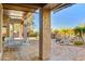 Serene covered patio with comfortable seating and a view of the desert landscaping and water feature at 22742 N 90Th St, Scottsdale, AZ 85255