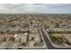 Expansive aerial view showcasing the neighborhood with mountain views in the distance on an overcast day at 22949 W Yavapai St, Buckeye, AZ 85326