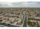 Birds-eye view of the suburban neighborhood showcasing its well-organized streets and green spaces with mountain views at 22949 W Yavapai St, Buckeye, AZ 85326