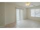 This is a bedroom with a ceiling fan, tile flooring, and vertical blinds on the windows at 22949 W Yavapai St, Buckeye, AZ 85326