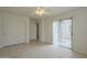 This bedroom features tile flooring, a ceiling fan, vertical blinds, and a double door closet at 22949 W Yavapai St, Buckeye, AZ 85326