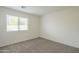 A spacious bedroom with large windows and neutral carpet creates a bright and inviting space at 22949 W Yavapai St, Buckeye, AZ 85326