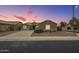 Well-maintained home with a manicured front yard and a freshly paved driveway at 22949 W Yavapai St, Buckeye, AZ 85326