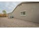 Exterior side view of the home with gravel landscaping and a privacy fence at 22949 W Yavapai St, Buckeye, AZ 85326