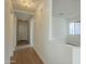 The bright hallway is illuminated by stylish ceiling fixtures and features wood-look flooring at 22949 W Yavapai St, Buckeye, AZ 85326