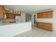 Spacious kitchen featuring white countertops, wood cabinets, and a functional breakfast bar at 22949 W Yavapai St, Buckeye, AZ 85326