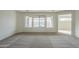 Bright and airy living room with plush gray carpet and neutral decor at 22949 W Yavapai St, Buckeye, AZ 85326