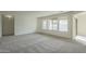 Inviting living room with large windows and plush gray carpet at 22949 W Yavapai St, Buckeye, AZ 85326