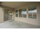 Covered patio featuring large windows, a sliding door, and neutral tones at 22949 W Yavapai St, Buckeye, AZ 85326