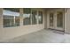 Covered patio featuring large windows, a sliding door, and neutral tones at 22949 W Yavapai St, Buckeye, AZ 85326