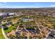 Aerial view of community park featuring pool, playgrounds, common areas and lush landscaping at 23004 E Desert Spoon Dr, Queen Creek, AZ 85142