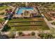 Aerial view of resort style pool, bocce ball court, and green spaces for community members at 23004 E Desert Spoon Dr, Queen Creek, AZ 85142