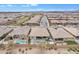 An aerial view of a desirable neighborhood, showcasing well-maintained homes and a sparkling community pool at 23004 E Desert Spoon Dr, Queen Creek, AZ 85142