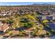 An aerial shot captures a serene park nestled within a vibrant residential neighborhood, complete with green spaces at 23004 E Desert Spoon Dr, Queen Creek, AZ 85142