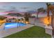 Beautiful backyard showcasing a modern pool, a cozy fire pit, and vibrant landscaping at 23004 E Desert Spoon Dr, Queen Creek, AZ 85142