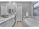 Bright bathroom featuring double sinks, bathtub and neutral paint at 23004 E Desert Spoon Dr, Queen Creek, AZ 85142