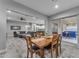 Dining room with a wood table, seating for six, and sliding glass doors to outdoor living area at 23004 E Desert Spoon Dr, Queen Creek, AZ 85142