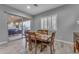 Dining area features a wood table, seating for six, and sliding glass doors to the backyard at 23004 E Desert Spoon Dr, Queen Creek, AZ 85142