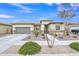 Charming single-story home featuring desert landscaping, large garage and inviting entryway at 23004 E Desert Spoon Dr, Queen Creek, AZ 85142