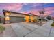 Stunning single-story home featuring manicured landscaping, a spacious driveway, and a two-car garage at 23004 E Desert Spoon Dr, Queen Creek, AZ 85142