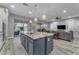 Open-concept kitchen featuring a large island, granite countertops, and stainless steel appliances at 23004 E Desert Spoon Dr, Queen Creek, AZ 85142