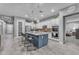 A kitchen with stainless steel appliances, a granite topped island with seating and hanging pendant lights at 23004 E Desert Spoon Dr, Queen Creek, AZ 85142