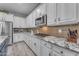 Modern kitchen with stainless steel appliances, tile backsplash, and granite countertops at 23004 E Desert Spoon Dr, Queen Creek, AZ 85142