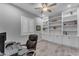 Home office featuring built-in bookshelves, plantation shutters, and a ceiling fan at 23004 E Desert Spoon Dr, Queen Creek, AZ 85142