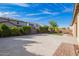 Spacious backyard featuring a brick paver patio, a grass area, and mature landscaping at 23072 N 98Th N Dr, Peoria, AZ 85383