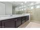 Bathroom featuring double sinks, white countertops, and walk-in shower at 23072 N 98Th N Dr, Peoria, AZ 85383