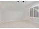 Bedroom with tile floor, ceiling fan and window with white plantation shutters at 23072 N 98Th N Dr, Peoria, AZ 85383