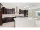 Modern kitchen with stainless steel appliances, and dark wood cabinets at 23072 N 98Th N Dr, Peoria, AZ 85383