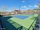 Pickle ball court at The Meadows with blue and green surface and view of community amenities at 23072 N 98Th N Dr, Peoria, AZ 85383