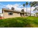 Expansive backyard with healthy green grass, covered patio, and mature trees at 2671 W Bentrup St, Chandler, AZ 85224