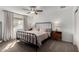 Cozy bedroom featuring a large bed, neutral tones, a ceiling fan and a window at 2671 W Bentrup St, Chandler, AZ 85224