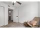 Bright bedroom featuring a rocking chair and view into the bathroom at 2671 W Bentrup St, Chandler, AZ 85224