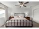 Comfortable bedroom showcasing a large bed, neutral tones, ceiling fan and a large window at 2671 W Bentrup St, Chandler, AZ 85224