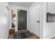 Bright entryway featuring wood floors, coat hooks, a decorative rug, and a view to the outside at 2671 W Bentrup St, Chandler, AZ 85224