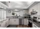 Bright kitchen featuring white cabinets, stainless steel appliances, granite countertops, and natural lighting at 2671 W Bentrup St, Chandler, AZ 85224