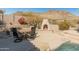 Backyard patio area with built-in fireplace and outdoor seating at 27561 N 84Th Dr, Peoria, AZ 85383