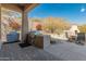 Covered patio with outdoor kitchen, fireplace and seating area at 27561 N 84Th Dr, Peoria, AZ 85383