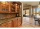 Close up of a built-in bar area with cabinets, counter space, and access to the pool area at 27561 N 84Th Dr, Peoria, AZ 85383