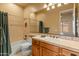 Bathroom with a tiled shower over tub, single sink vanity, and a large mirror at 27561 N 84Th Dr, Peoria, AZ 85383