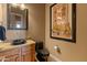 Modern half-bathroom with granite countertop, vessel sink, contemporary fixtures, and stylish decor at 27561 N 84Th Dr, Peoria, AZ 85383