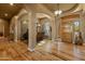 View of a dining area with stone wall and foyer leading to the front door at 27561 N 84Th Dr, Peoria, AZ 85383