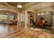 Bright dining area featuring wood floors, stone accent wall, and chandelier lighting at 27561 N 84Th Dr, Peoria, AZ 85383